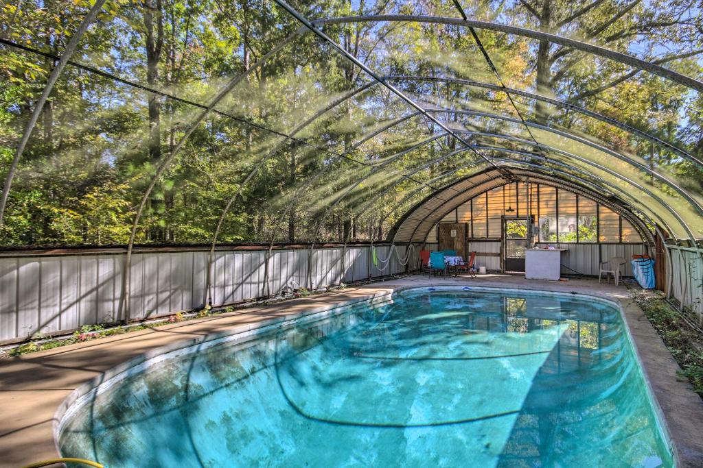 a large swimming pool with an archway in a building at Clarks Hill Lake Area Home with Pool and Dock! in Lincolnton