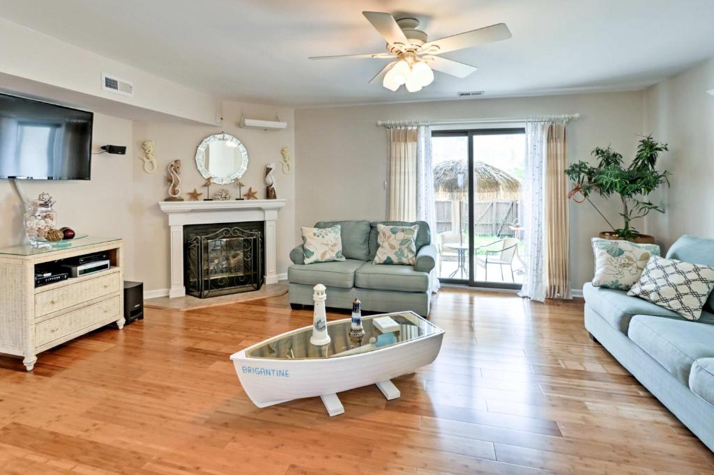 a living room with a couch and a fireplace at Brigantine Townhome Near Beaches and AC Casinos in Brigantine