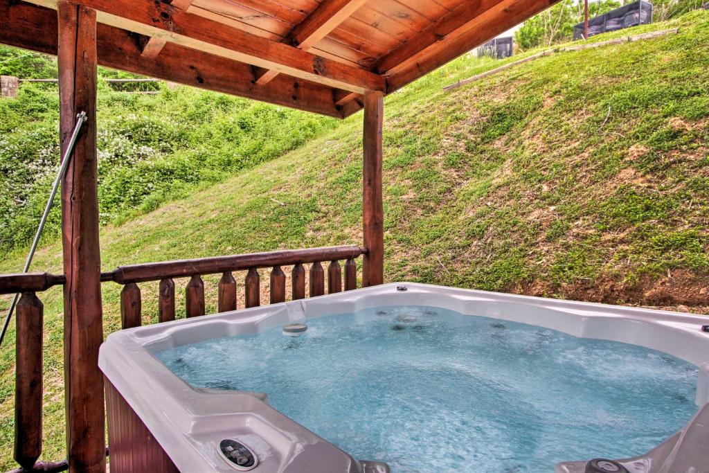 a hot tub on the deck of a cabin at Expansive Gatlinburg Cabin Hot Tub, Deck and Grill! in Gatlinburg