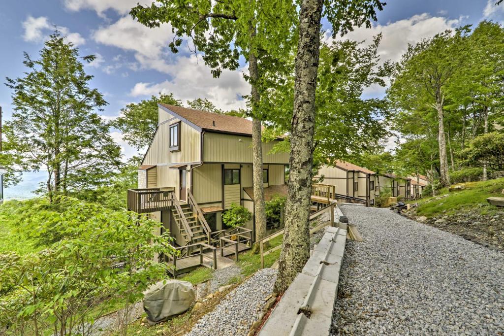 a house in the woods with a gravel road at All-Season Base w/ Views in Beech Mountain! in Beech Mountain