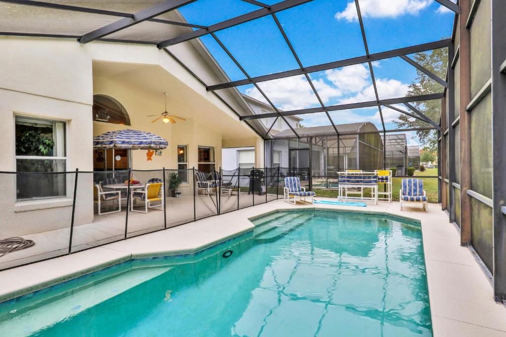 an indoor swimming pool with a glass ceiling at Cumbrian Lakes Villa in Kissimmee