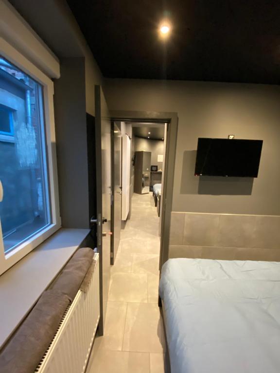 a hospital room with a bed and a flat screen tv at Appartement Studio Tournai in Tournai