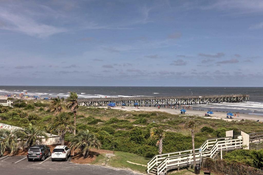 a view of a beach with a pier at Isle of Palms Beachfront Condo with Balcony and Pool! in Isle of Palms