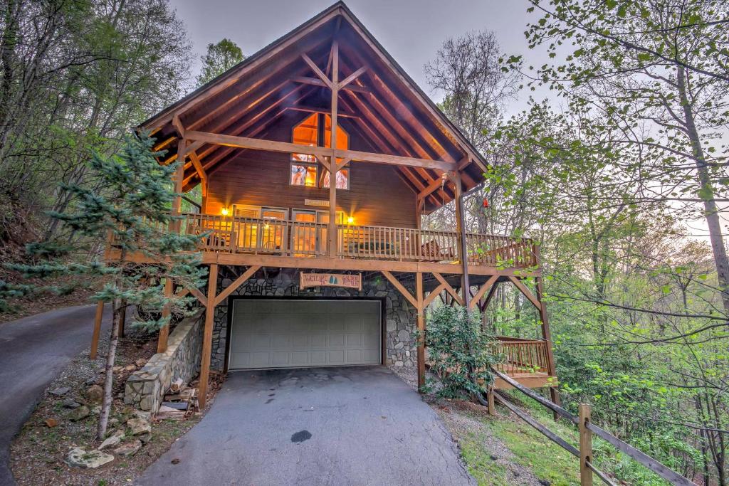 a cabin in the woods with a garage at Spacious Maggie Valley Cabin with Hot Tub and MTN View in Maggie Valley