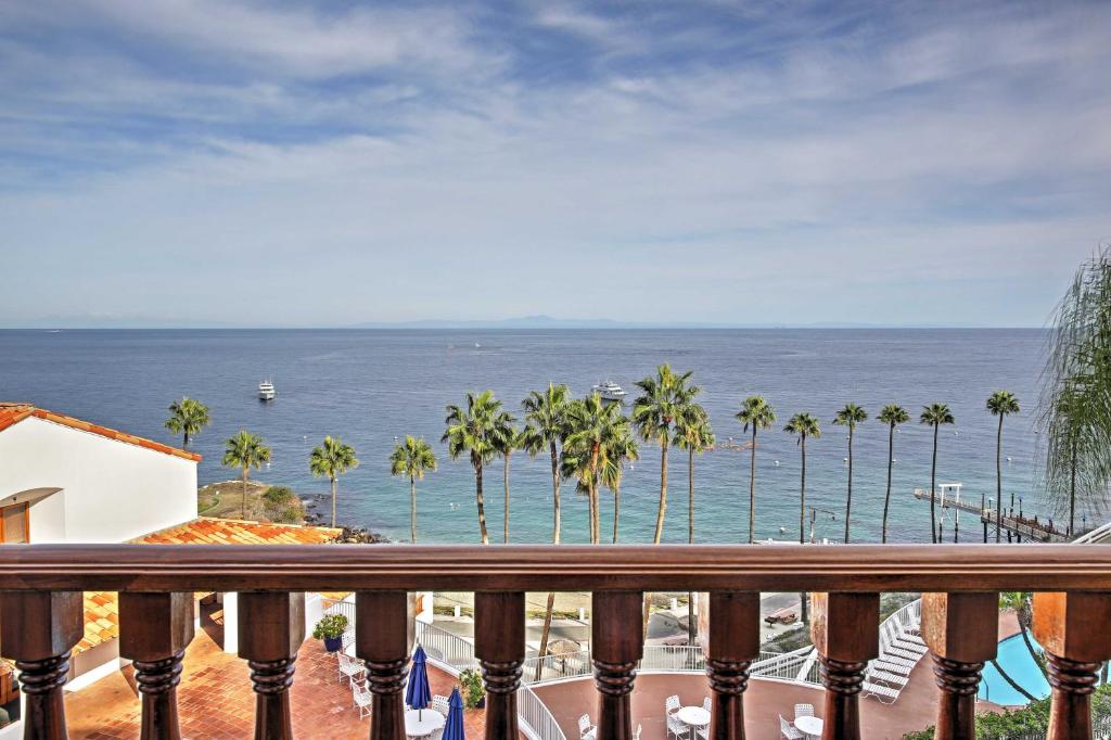 a balcony with a view of the ocean and palm trees at Quiet Avalon Getaway Villa with Ocean View and Balcony in Avalon