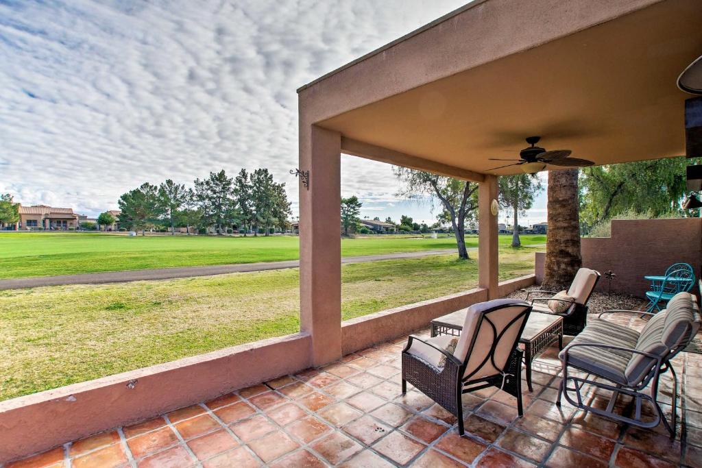 a porch with chairs and a view of a field at Golf Escape with Patio, Pool Access and Entertainment! in Mesa