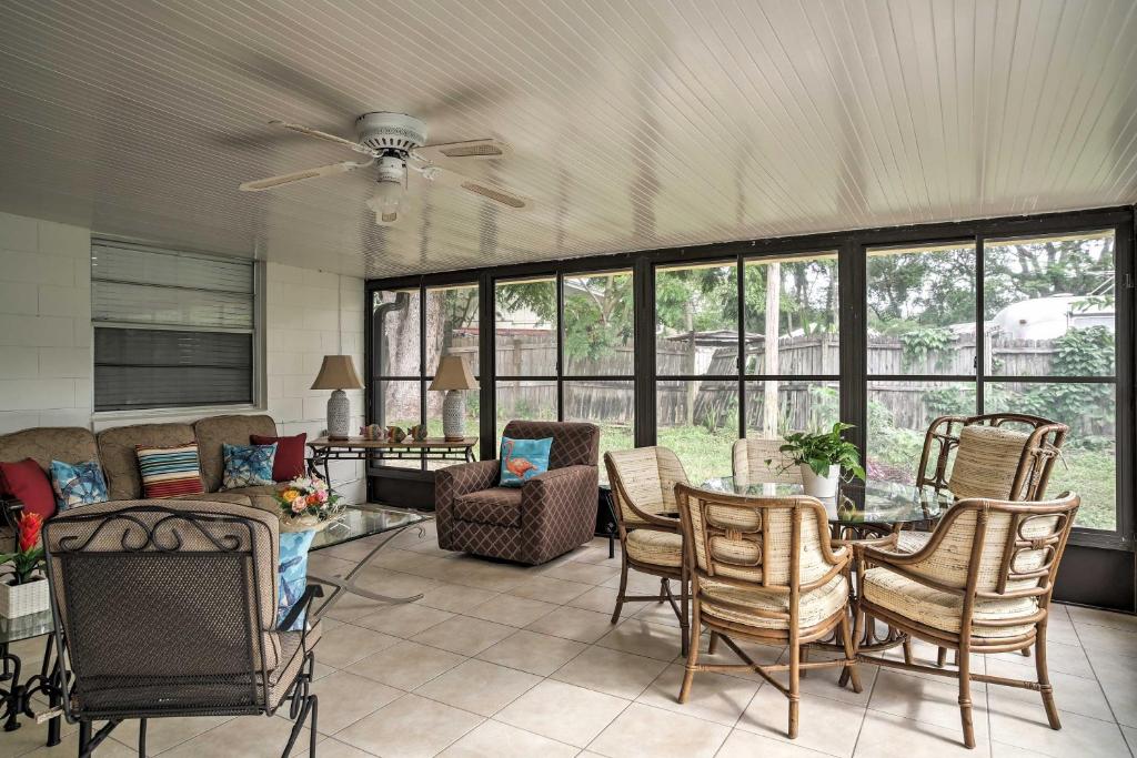 a living room with a couch and a table and chairs at Quiet Home Near Shopping and 15 Miles From Orlando! in Orlando