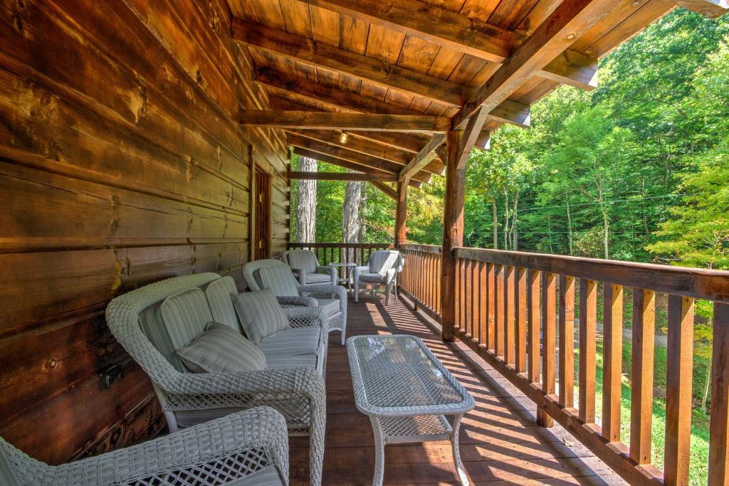 a porch of a cabin with chairs and a grill at Scenic Trade Cabin with Deck Near Boone and App State! in Trade