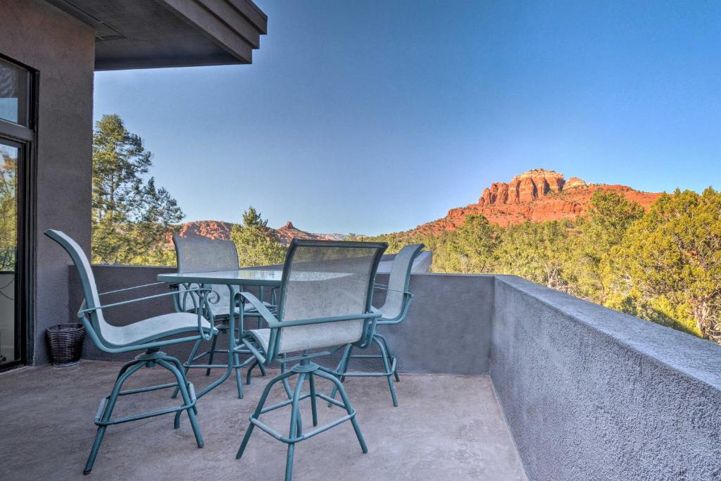 
an outdoor patio with chairs and a bench at 2-Acre Sedona Casita with Deck and Red Rock Views! in Sedona
