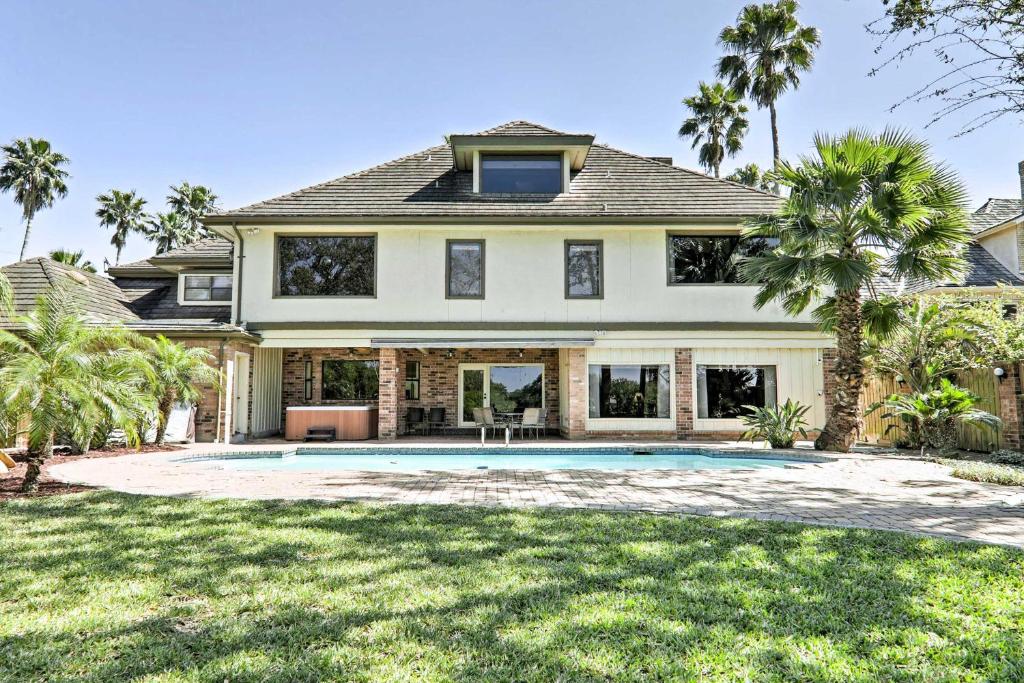 a house with a swimming pool in the yard at Lakefront Harlingen Home with Pool, Yard and Pool Table in Harlingen