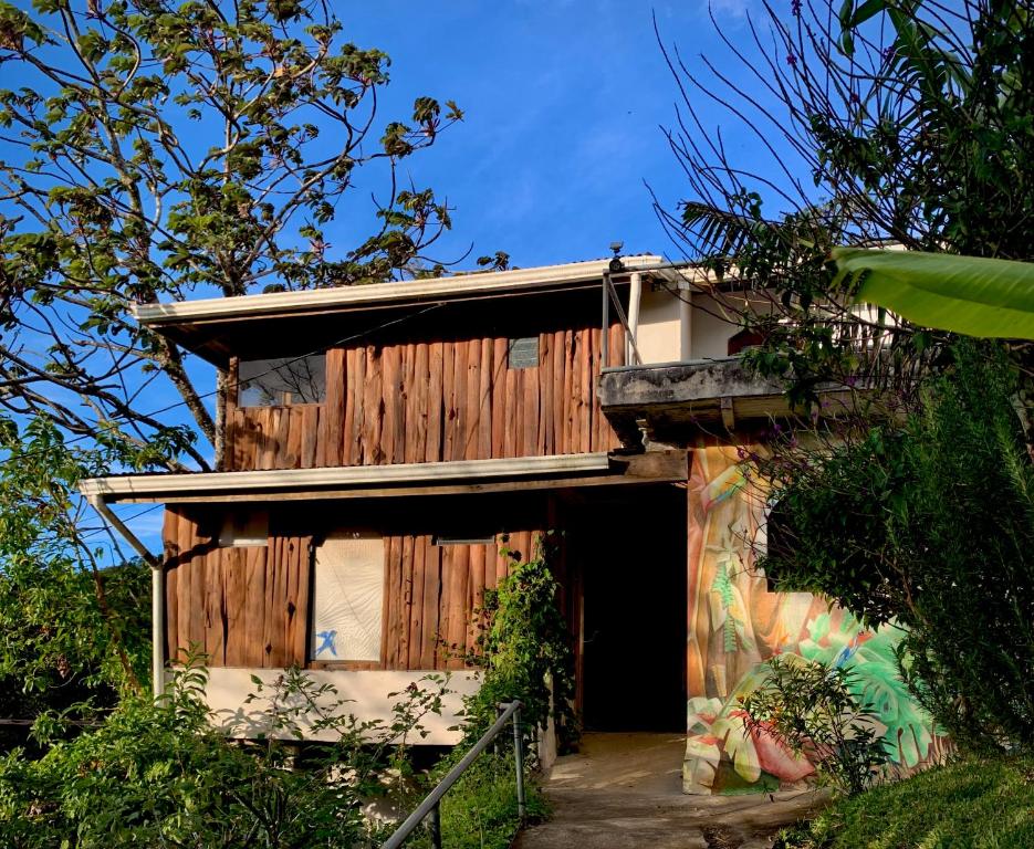 a wooden building with a door in a yard at Casa Alquimia in Monteverde Costa Rica