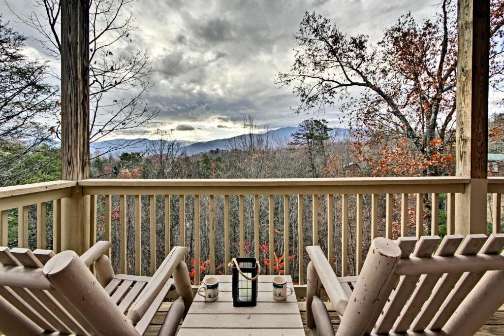 two chairs on a deck with a view of the mountains at Gatlinburg Cabin with Pool Table and Hot Tub! in Gatlinburg