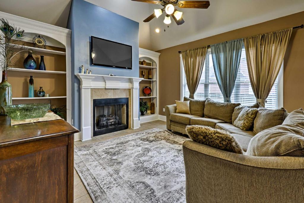 a living room with a couch and a fireplace at Cordova Home with Pool Table, 17 Mi to Memphis Zoo! in Cordova