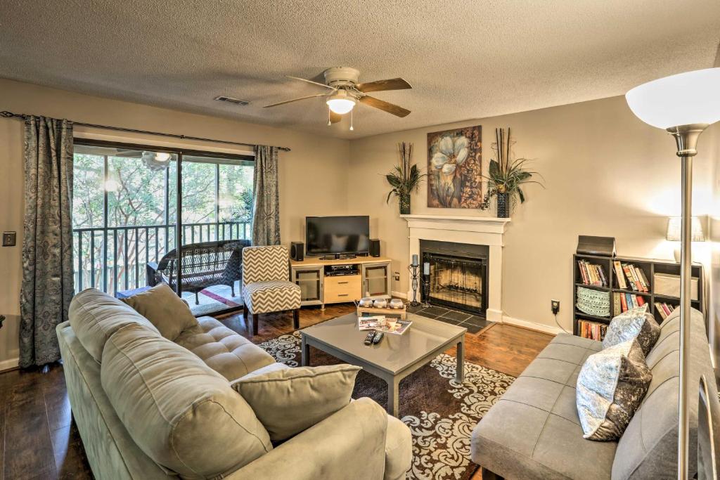 a living room with a couch and a fireplace at Mount Pleasant Condo - Near Charleston and Beaches! in Charleston