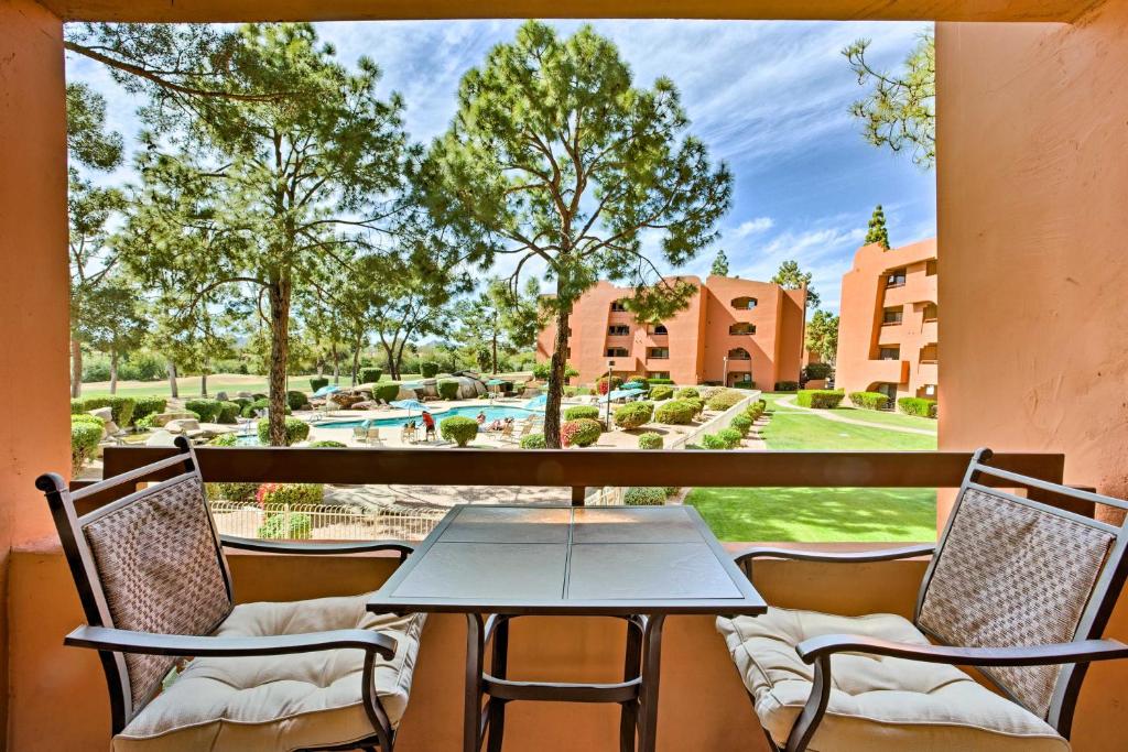 a table and chairs on a balcony with a view of a pool at Anasazi Village Condo, 8Mi to Phoenix Mtn Preserve in Phoenix