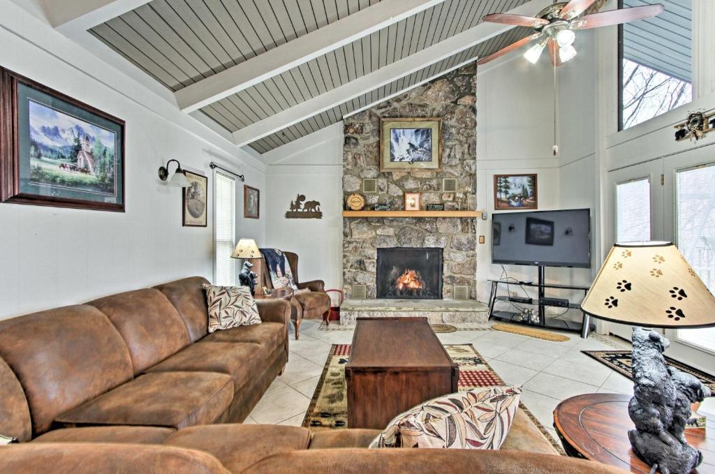 a living room with a couch and a fireplace at Gatlinburg Home Mountain Views and Indoor Hot Tub! in Gatlinburg