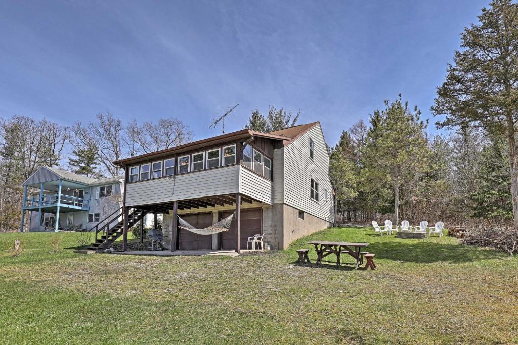 a large house with a picnic table in a field at Auburn Vacation Rental Home Near Owasco Lake! in Auburn