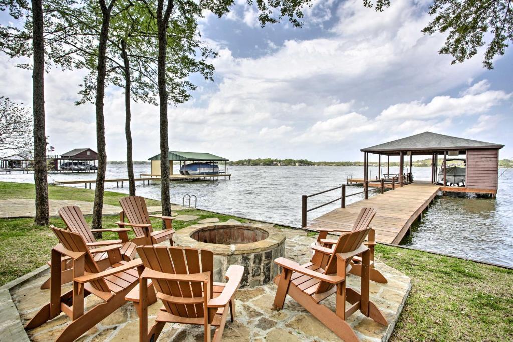 a dock with chairs and a fire pit on the water at Malakoff Home with Deck and Fire Pit Cedar Creek Lake in Malakoff