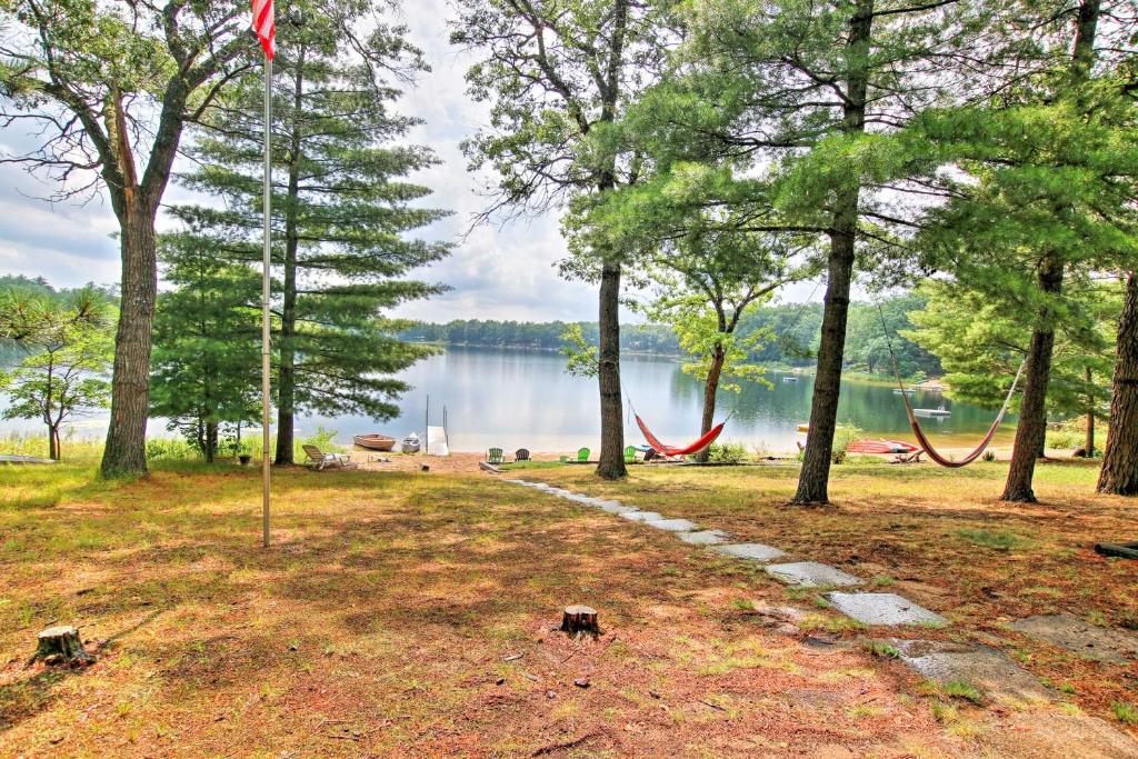a park with a view of a lake and trees at Baldwin Cabin with Private Beach on Little Lake! in Baldwin