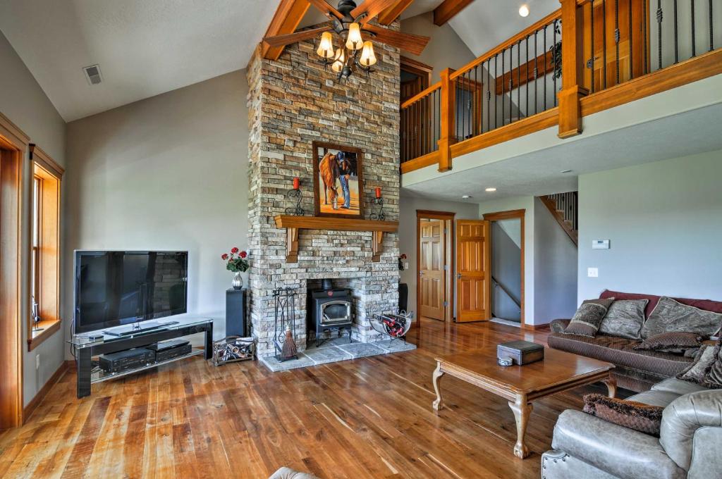 a living room with a fireplace and a tv at Custom Home with Decks in Boulder! Gateway to Parks! in Boulder Town