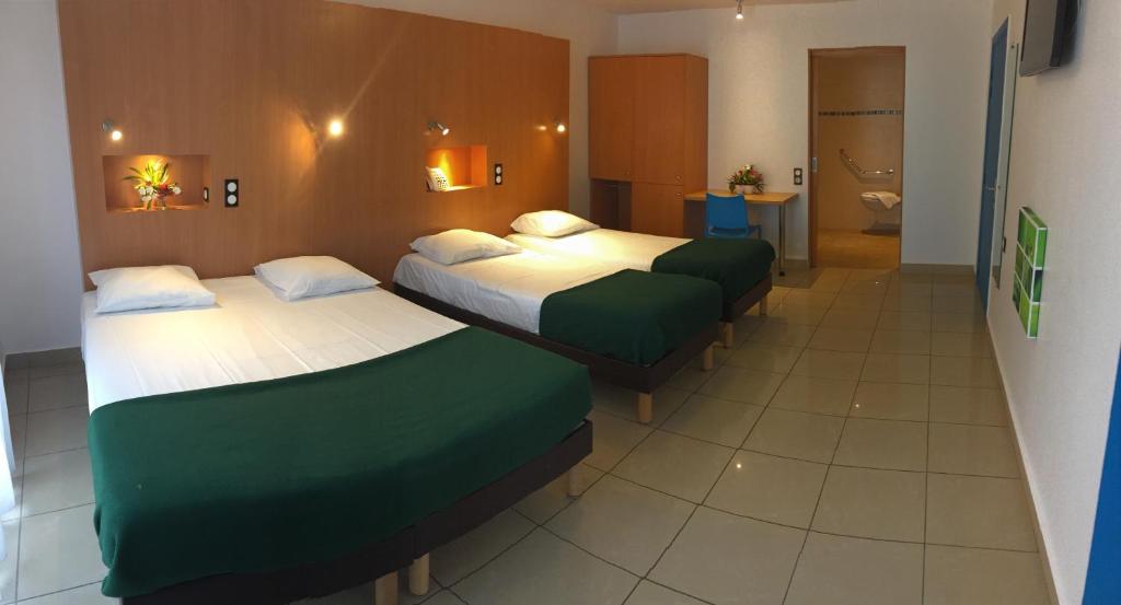 Postel nebo postele na pokoji v ubytování Karaibes Hotel