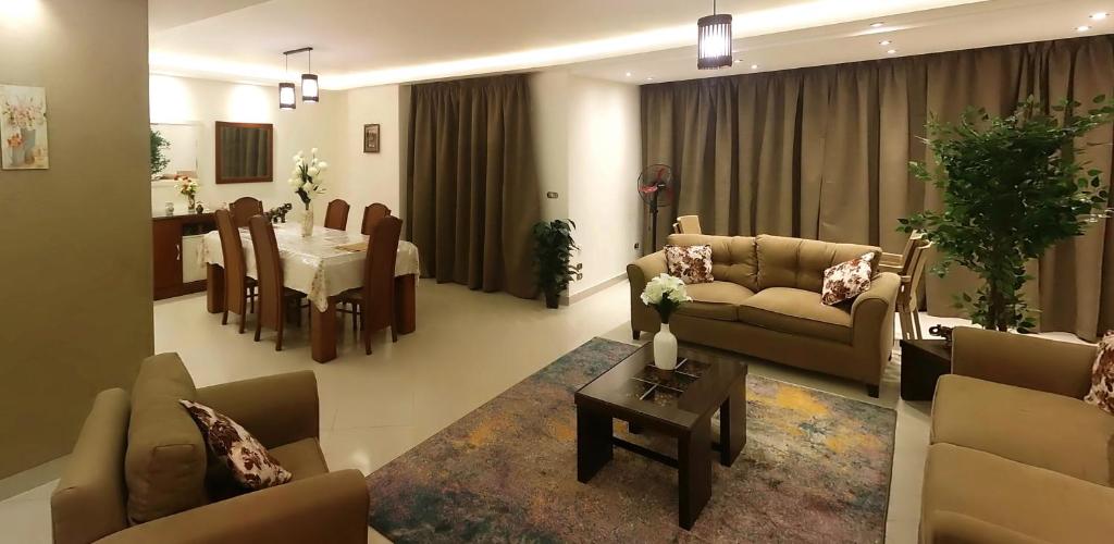 a living room with couches and a dining room at Luxury Furnished Apartment in Cairo