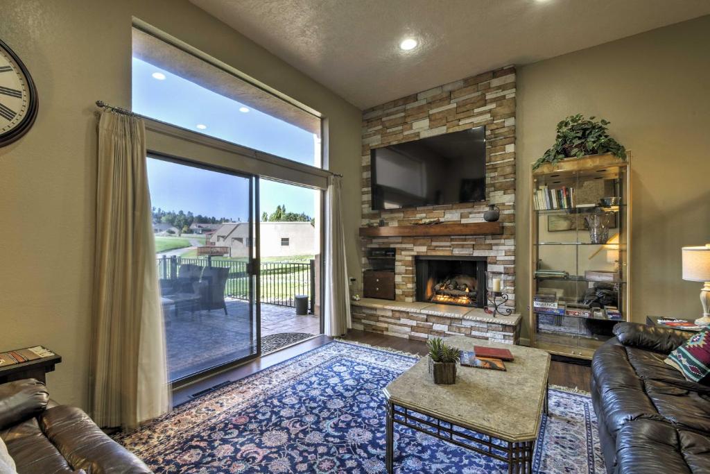 a living room with a couch and a fireplace at Ruidoso Golf Condo - Patio, Fire Pit and Mtn View! in Ruidoso