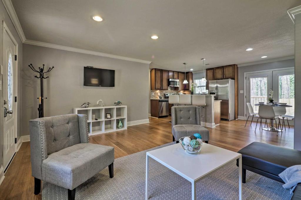 a living room with a couch and a table at Comfortable Ranch Home - 5 Mi to Downtown Atlanta! in Atlanta