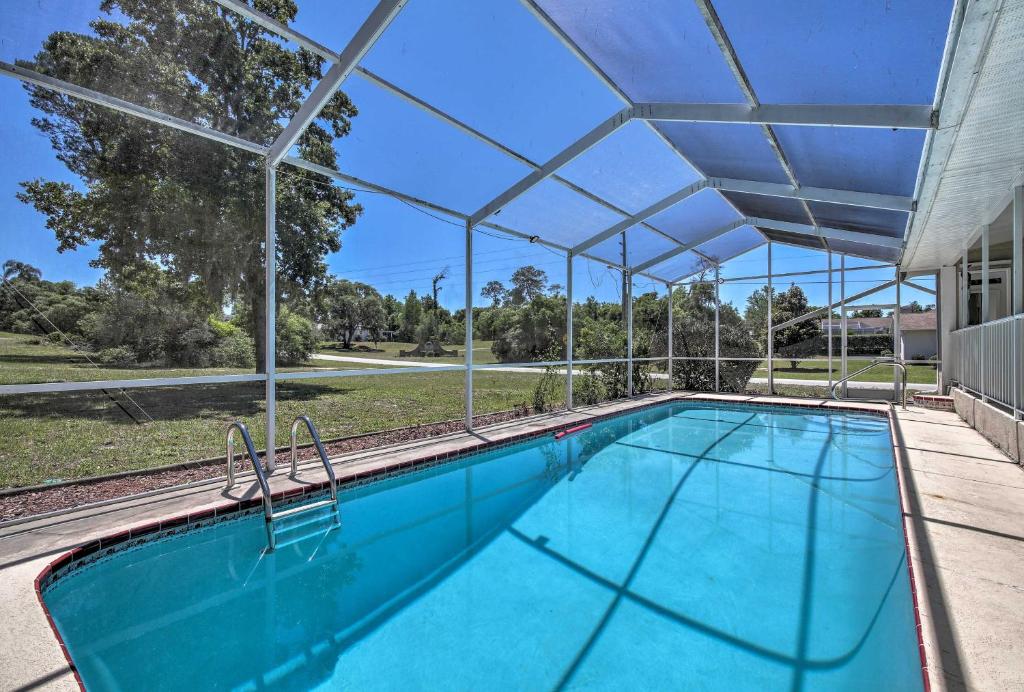 an overhead swimming pool with an umbrella over it at Spring Hill Home with Pool about 1 Mi to Weeki Wachee in Spring Hill