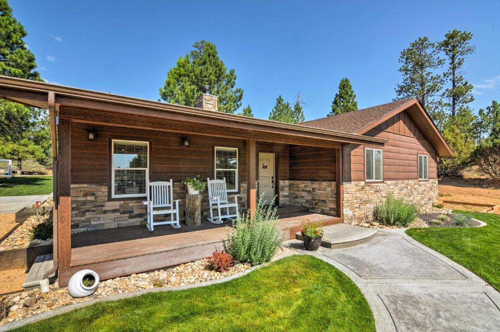 a house with a deck and two chairs on it at Luxe Home about 2 Mi to Bryce Canyon National Park! in Bryce Canyon