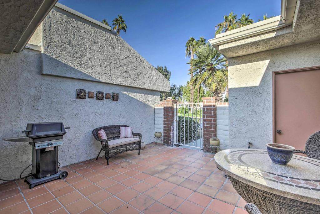 een patio met een grill en een open haard bij Condo with Pool Access Near Downtown Palm Springs! in Cathedral City