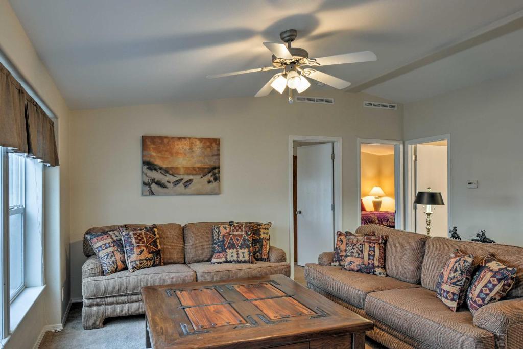 a living room with a couch and a ceiling fan at Ranch House in Boulder! Gateway to Nearby Parks! in Boulder Town