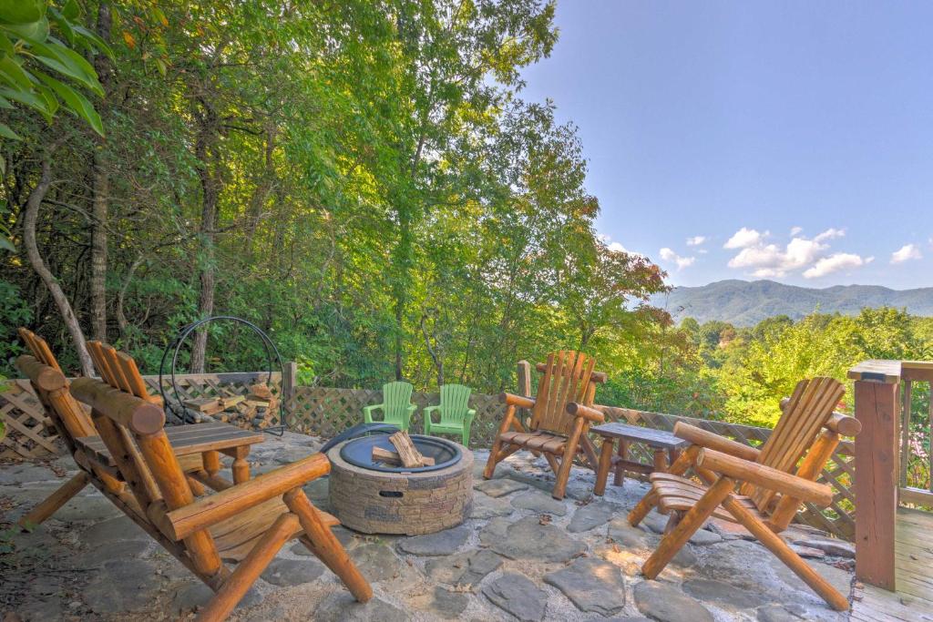 a group of chairs sitting around a fire pit at Beautiful Bryson City Home with Hot Tub and Mtn Views! in Bryson City