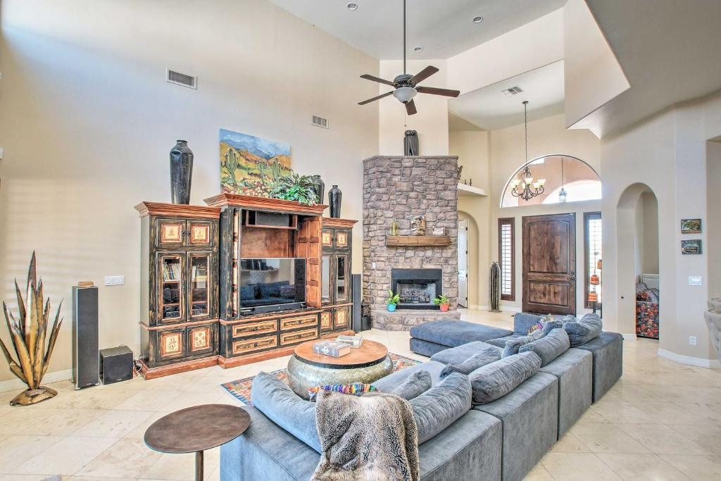 a living room with a large couch and a fireplace at Scottsdale, Rio Verde Getaway Less Than 3 Mi to Golf Club! in Scottsdale