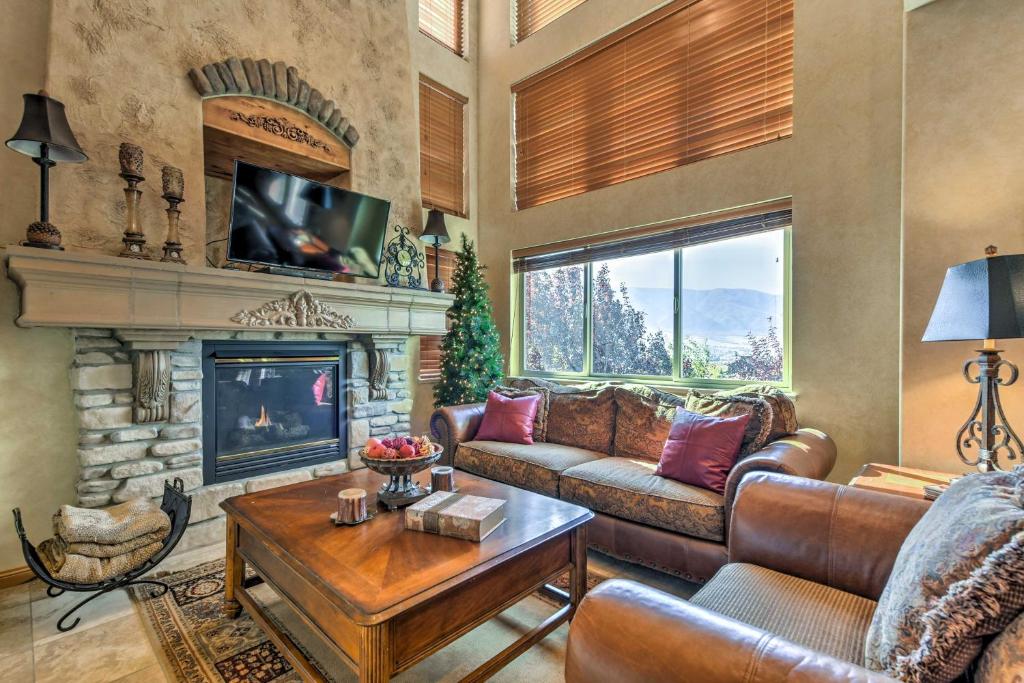 a living room with a couch and a fireplace at Eden Townhome with Mtn View and Shuttle to Powder Mtn! in Eden