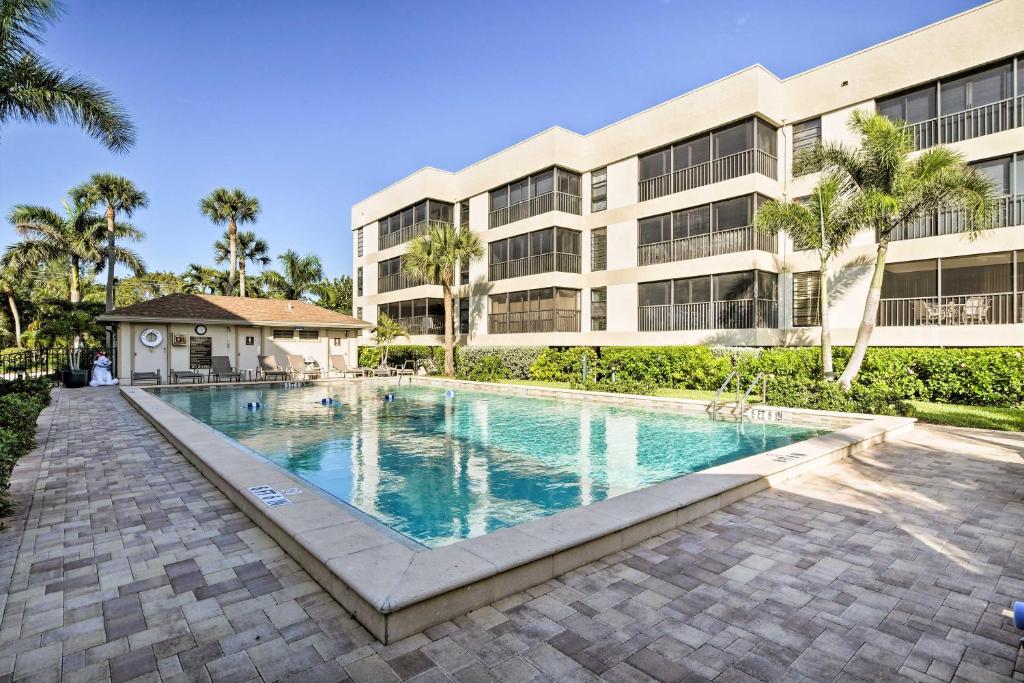 a swimming pool in front of a building at Luxury Sanibel Condo with Ocean View Steps to Beach in Sanibel