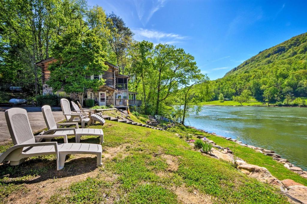 a group of chairs sitting next to a river at Tenn River Cabin with Hot Tub - 10 Mi to Chattanooga! in Chattanooga