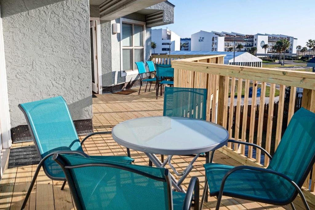 a deck with chairs and a table and chairs at Port Aransas Condo with Pool Access Walk to Beach! in Mustang Beach