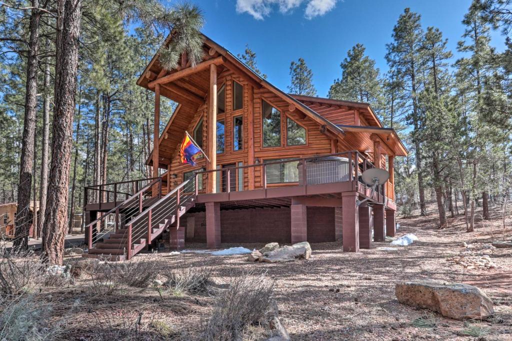 a log cabin in the woods with a wrap around deck at Private 1-Acre Lakeside Escape with Wraparound Deck in Lake of the Woods