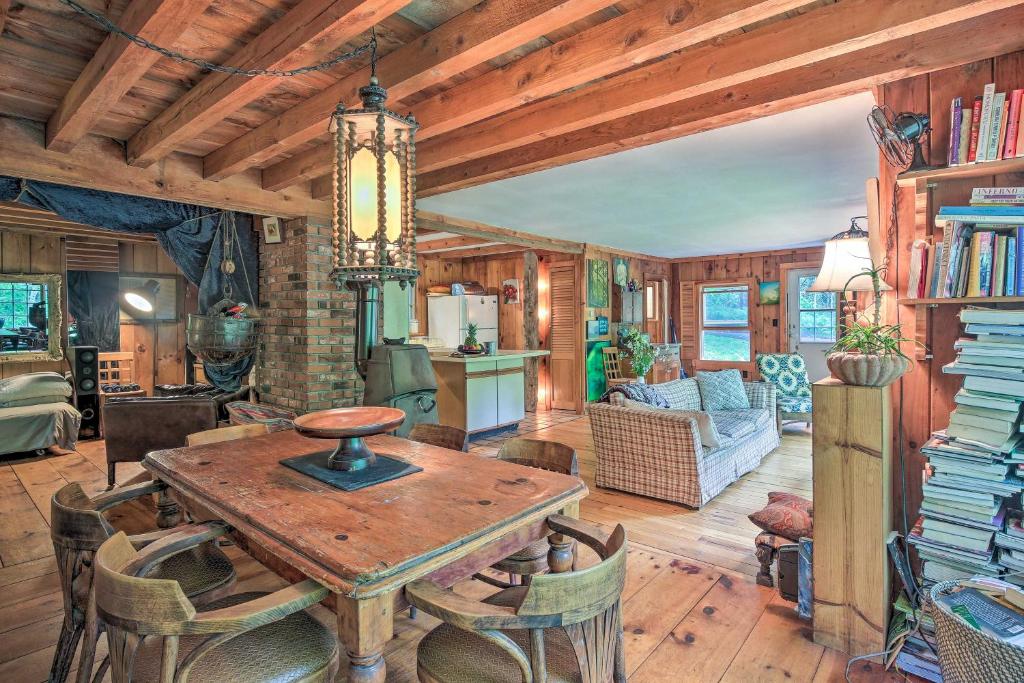 a kitchen and living room with a table and chairs at Berkshire Riverfront Ski Cabin: Close to Hiking! in Mill River
