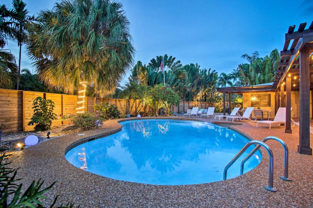 a swimming pool in the backyard of a house at Updated and Private Oakland Park Gem about 2 Mi to Beach in Fort Lauderdale