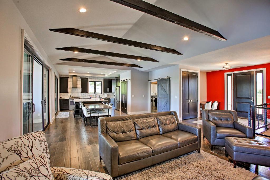 a living room with couches and a dining room at Sunroom and Hot Tub! Waterfront Silver Lake Home in Traverse City