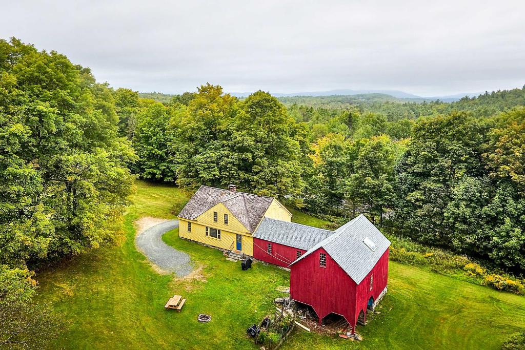 an aerial view of a red and yellow barn at Historic Hanover Area Home, 16 Miles to Dartmouth! in Enfield