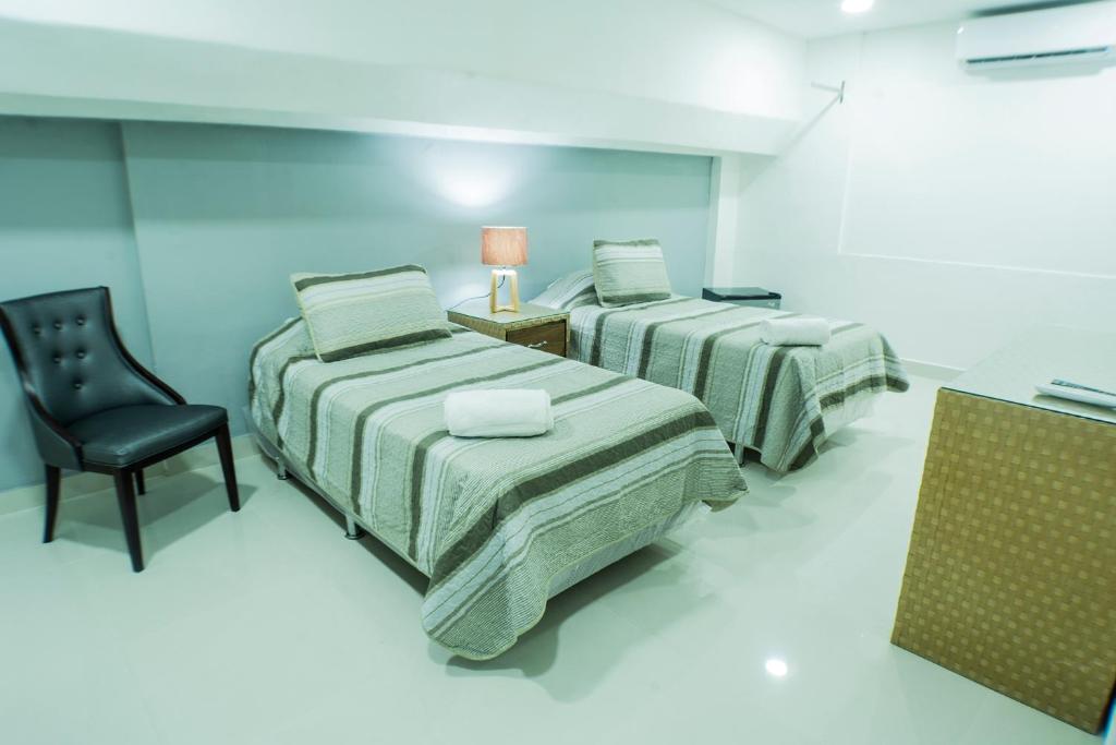 Postel nebo postele na pokoji v ubytování Malecon Premium Rooms & Hotel