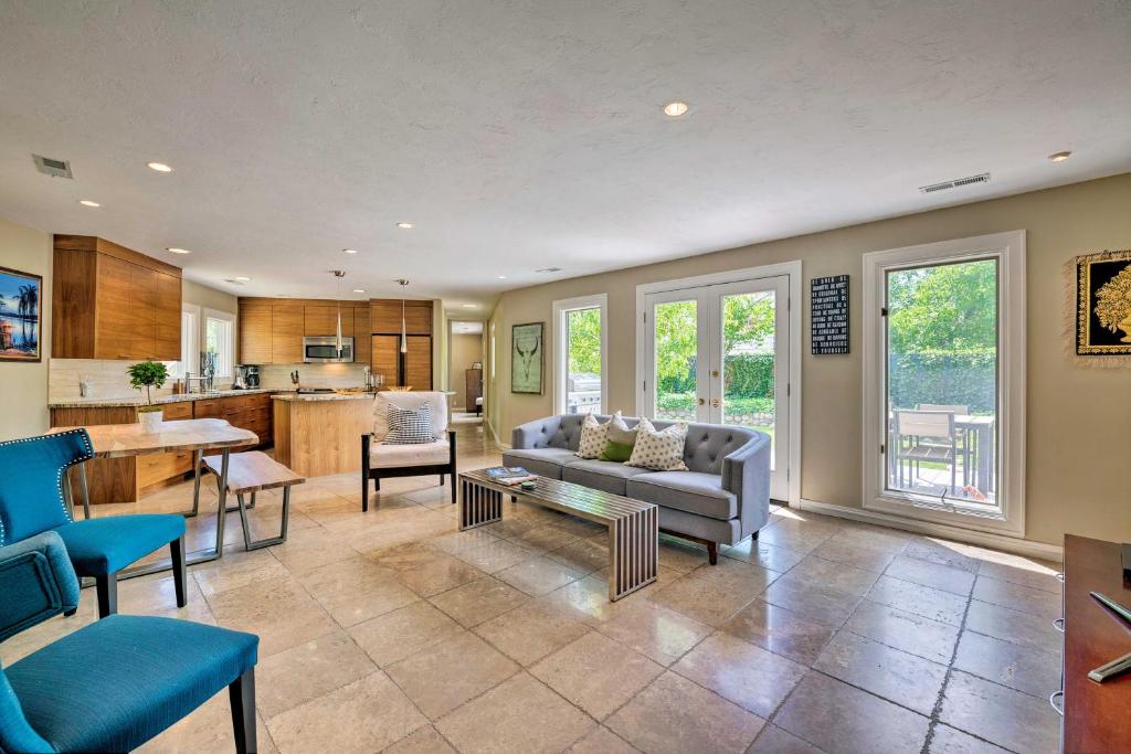 a living room with a couch and a table at Salt Lake City Home with Koi Pond and Furnished Deck! in Salt Lake City