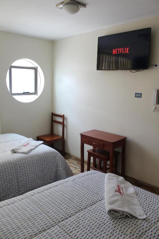 Postel nebo postele na pokoji v ubytování Hostal Inkanto Taruma