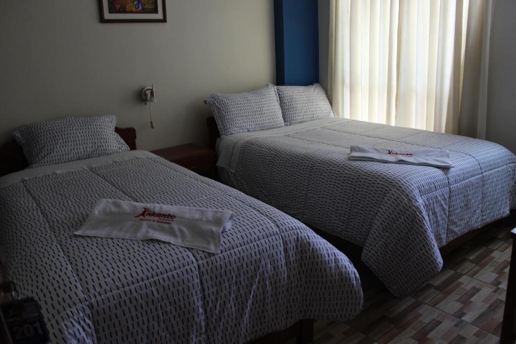 Postel nebo postele na pokoji v ubytování Hostal Inkanto Taruma