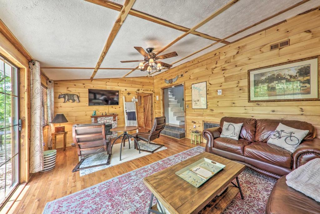 a living room with a couch and a table at Getaway on Center Hill Lake with Decks and Water Views in Silver Point