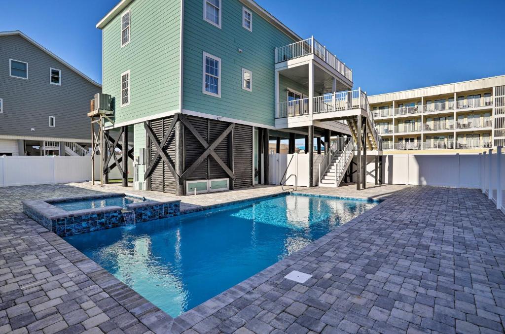a house with a swimming pool in front of a building at Spacious Murrells Inlet Hub with Pool, Walk to Shore in Myrtle Beach