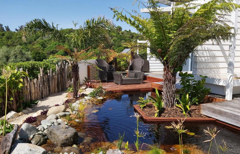 a garden with a koi pond in the yard at The Bay Lodge in Pohara